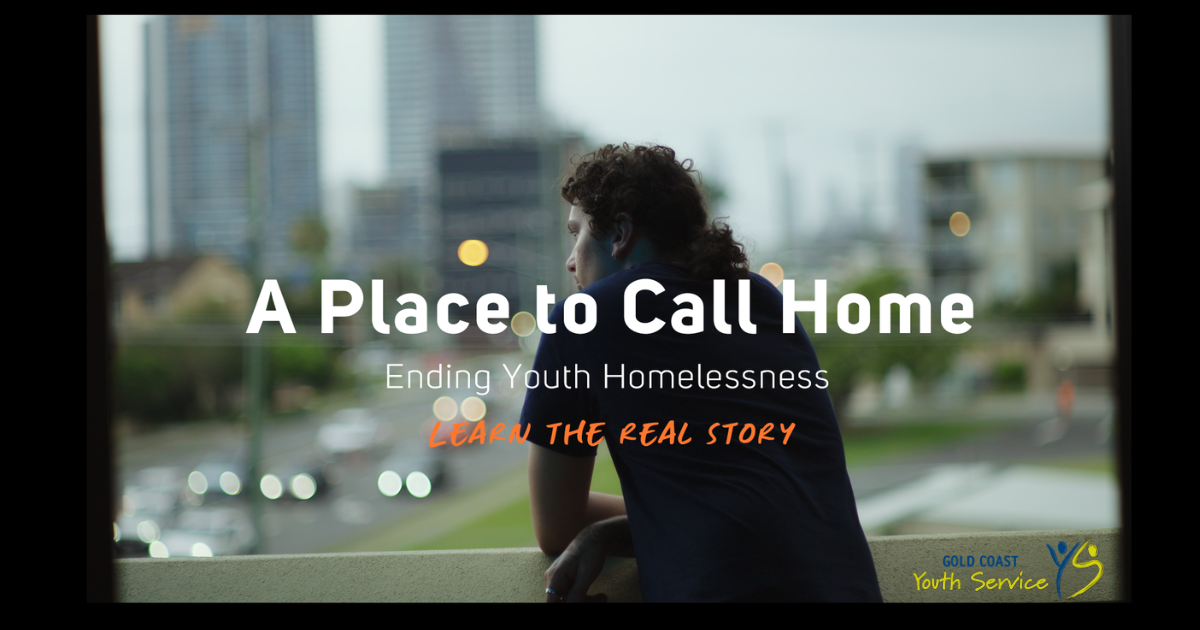 Young person looking down over balcony